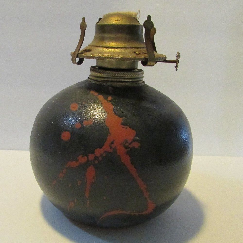 vintage black glazed red clay oil lamp base marked S Penn abstract design